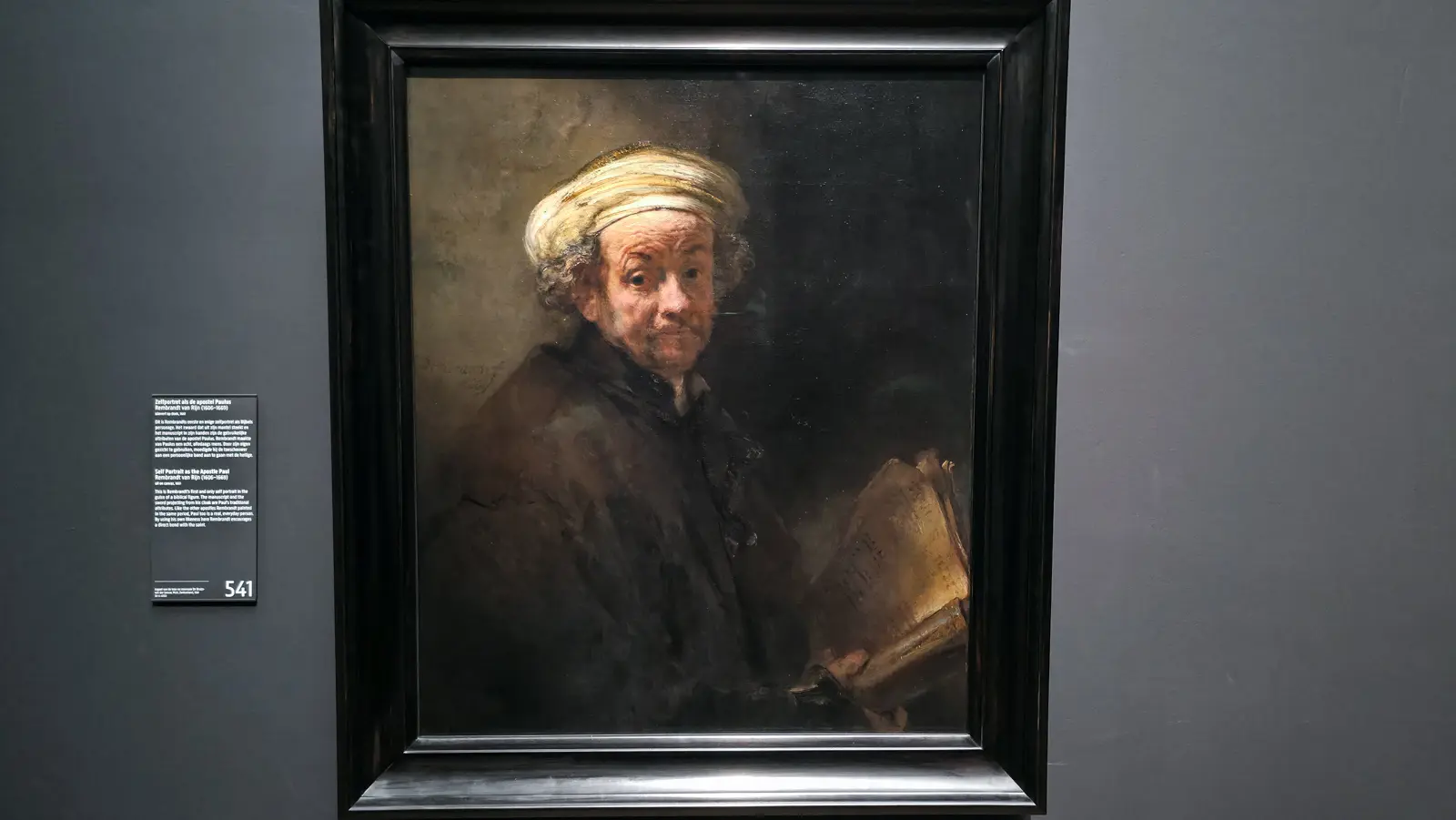 Rembrandt’s Self Portrait as the Apostle Paul at the Rijksmuseum, an elderly man in a pale turban holding an open manuscript
