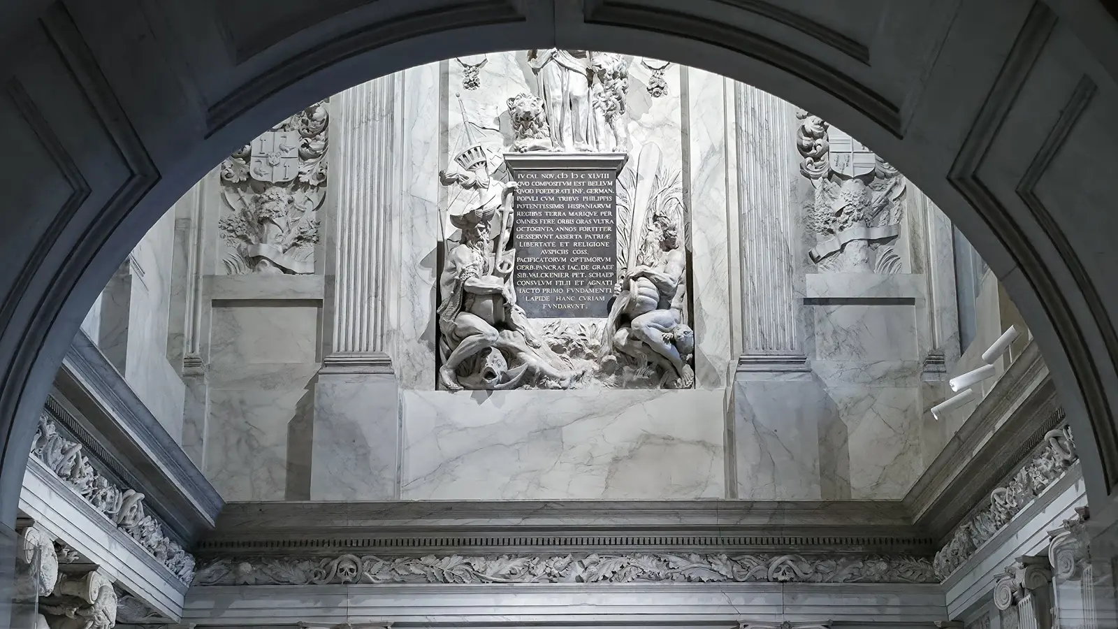 A marble relief and Latin inscription tablet high on the wall of the Vierschaar in the Royal Palace Amsterdam