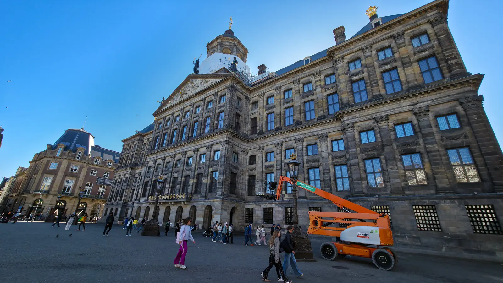 The Royal Palace Amsterdam on Dam Square, cupola wrapped for maintenance, seen from the square where executions took place