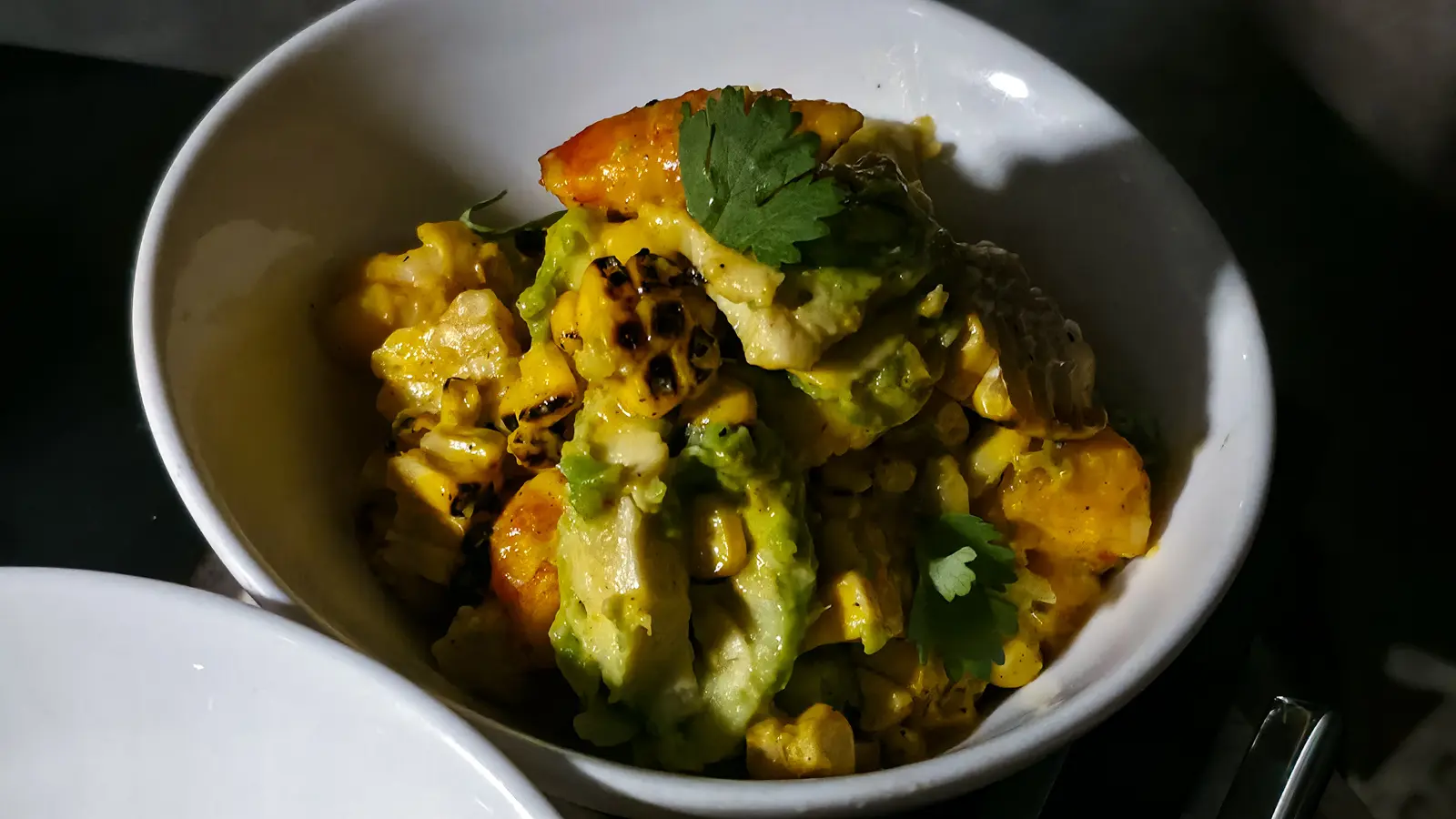 A bowl of jumbo prawn with grilled corn, avocado and coriander in a dried chilli sauce at the W Lounge, W Amsterdam