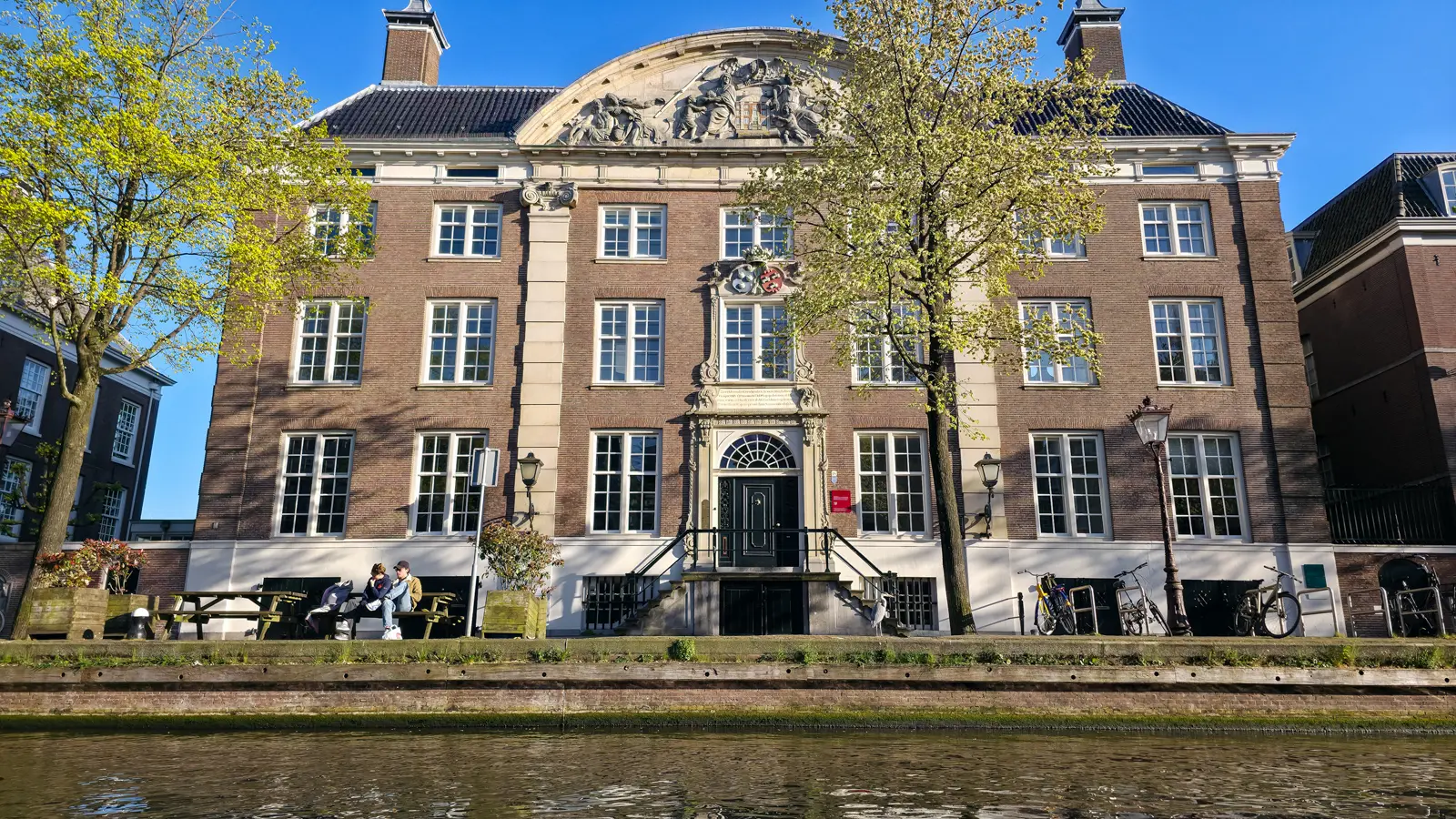 The Corvershof almshouse on the Nieuwe Herengracht in Amsterdam, with its sculpted curved pediment, sandstone pilasters and double flight of steps