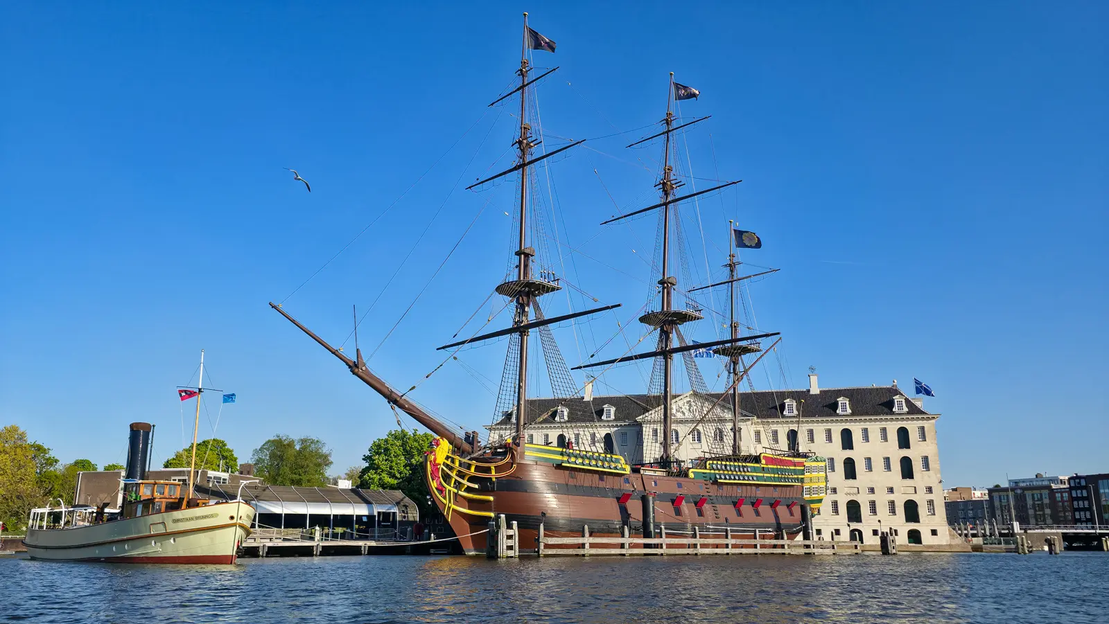 Replica of the VOC ship Amsterdam moored beside the steamship Christiaan Brunings in front of Het Scheepvaartmuseum, Amsterdam