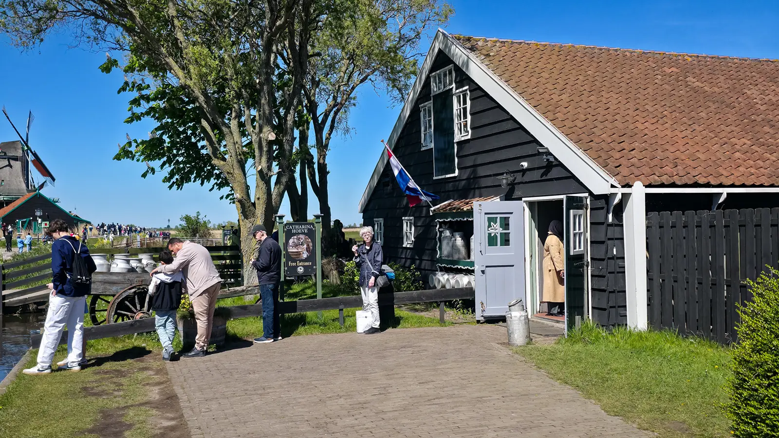 The black timber farmhouse of Catharina Hoeve with a Dutch flag and open stable door, Zaanse Schans