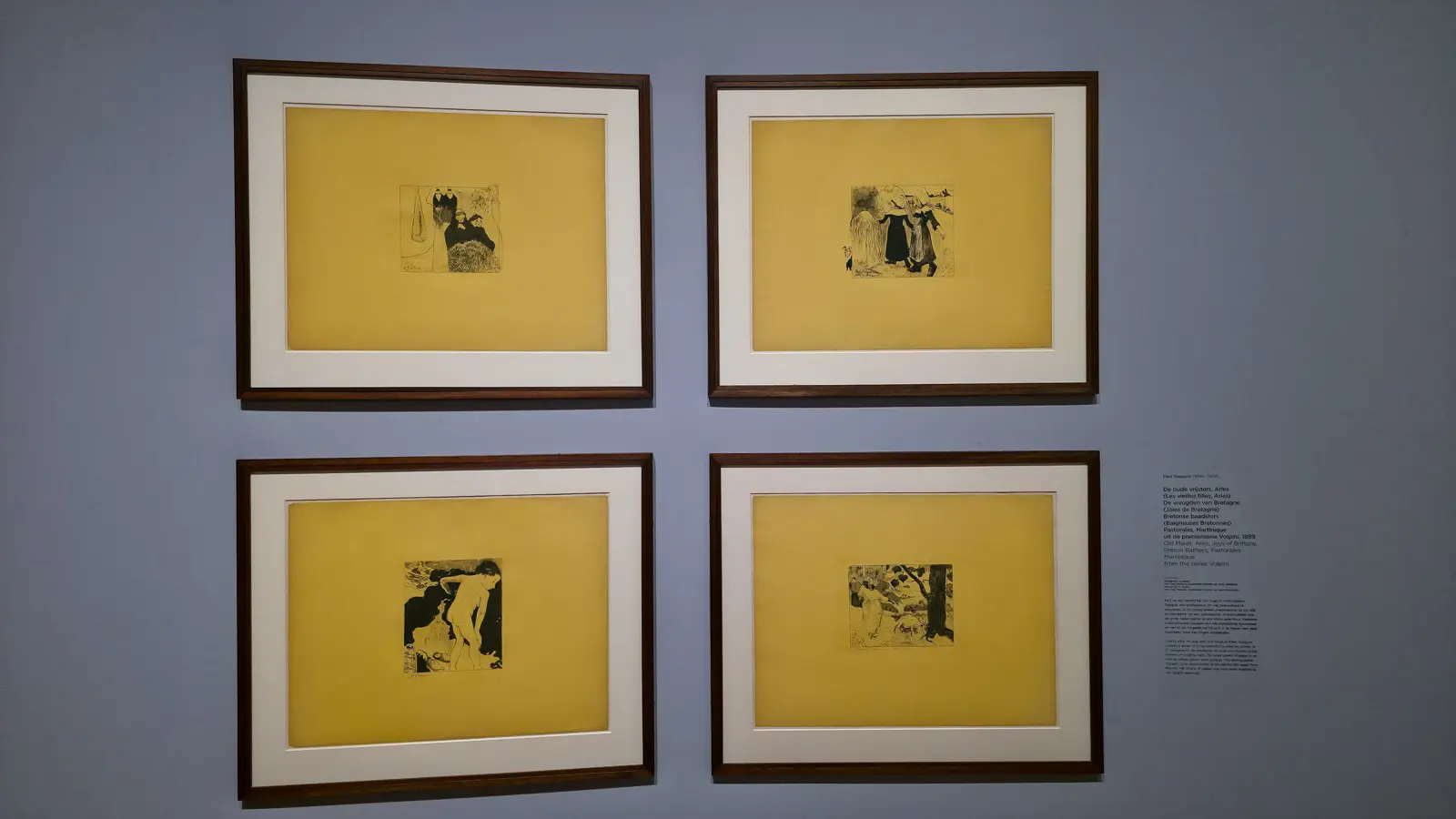 Four prints from Paul Gauguin's Volpini series (1889), black images on large sheets of bright yellow paper, framed in a grid at the Van Gogh Museum
