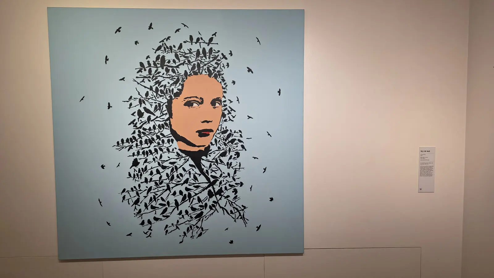 Let Her Be Free by Icy and Sot, a woman's face and hair formed from hundreds of small black birds on branches against a pale blue ground, Moco Museum, Amsterdam
