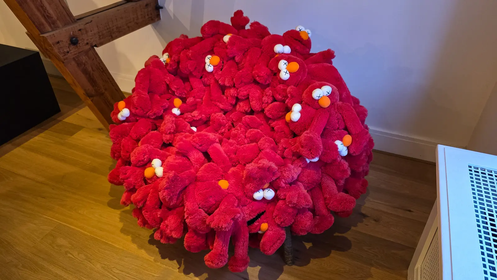 Monster Chair by KAWS and Estudio Campana, an armchair built from dozens of red Elmo plush toys with orange noses pointing in every direction, Moco Museum, Amsterdam