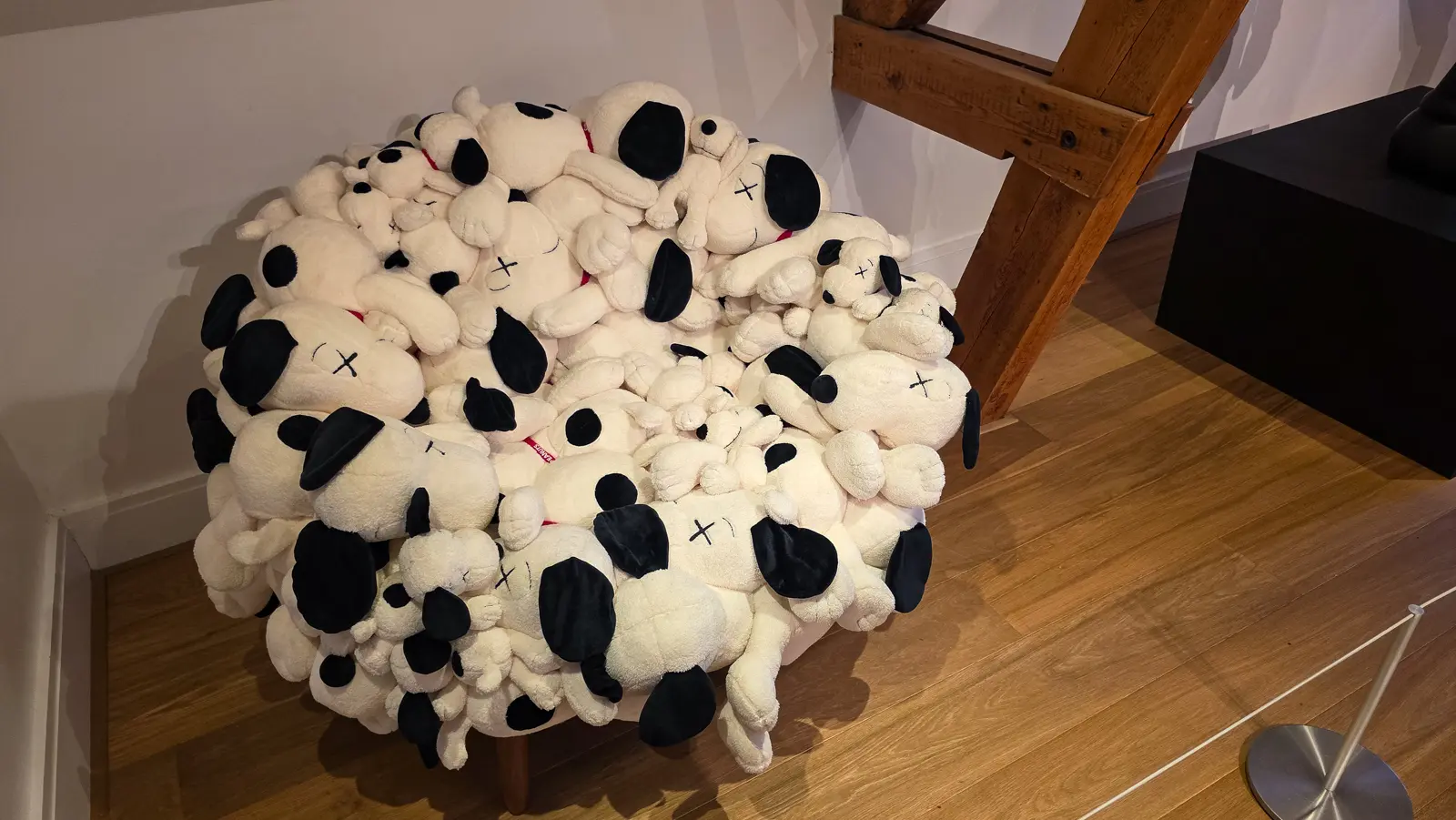 Man's Best Friend Sofa by KAWS and Estudio Campana, an armchair built from dozens of white Snoopy plush toys with crossed-out eyes on a steel and wood frame, Moco Museum, Amsterdam