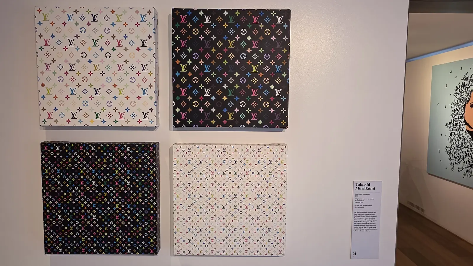 Four Takashi Murakami Louis Vuitton multicolour monogram canvases hung in a square, two on white grounds and two on black, at the Moco Museum, Amsterdam