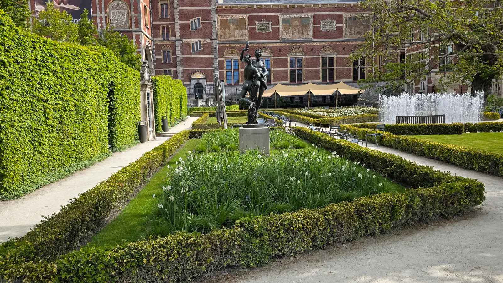 Formal parterre of white narcissi and low clipped hedges, with a bronze on a plinth, Rijksmuseum gardens, Amsterdam