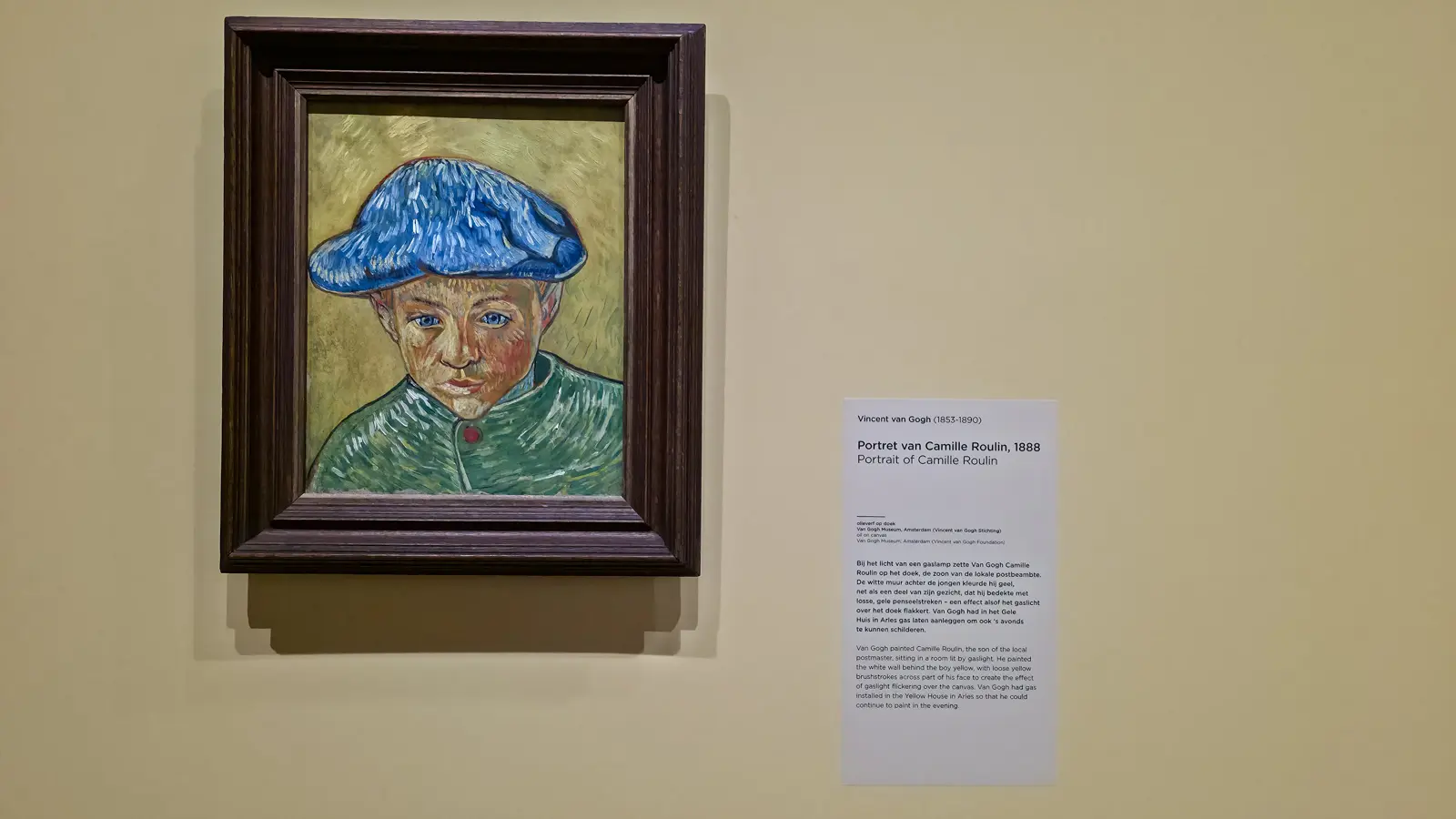 Van Gogh's Portrait of Camille Roulin (1888), a boy in a blue cap against a yellow background, in a dark wood frame at the Van Gogh Museum