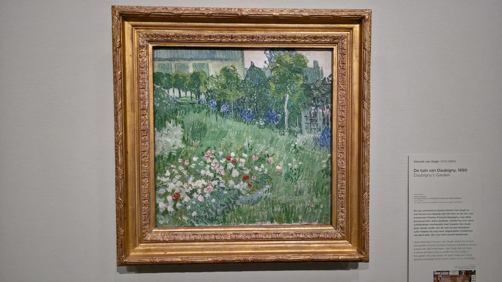 Van Gogh's Daubigny's Garden (1890), a green lawn with pink and white roses and trees, painted in Auvers-sur-Oise, at the Van Gogh Museum
