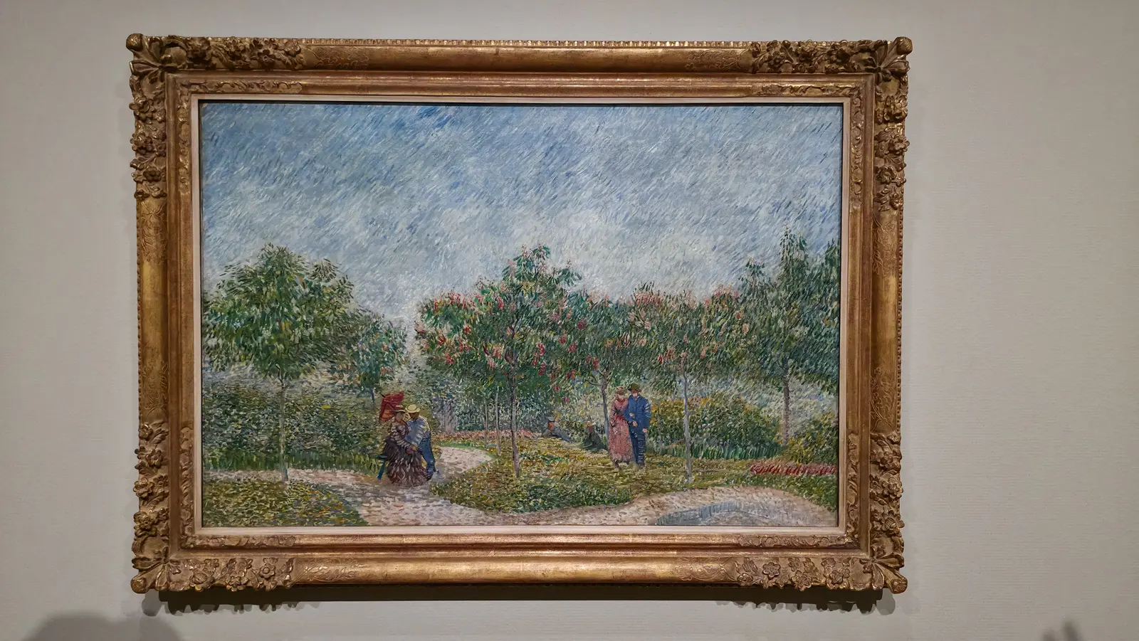 Van Gogh's Garden with Courting Couples: Square Saint-Pierre (1887), couples walking under flowering chestnuts beneath a streaked blue sky, Van Gogh Museum
