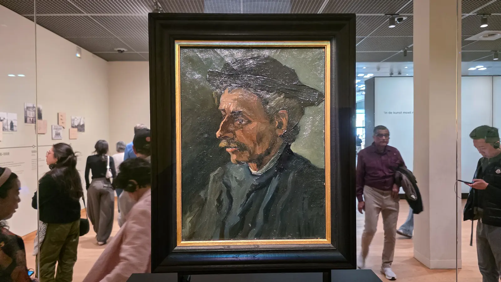 Head of a Man, 1885, thick paint, a dark cap and a moustache, a face built out of ridges, displayed in a freestanding glass case, Van Gogh Museum, Amsterdam