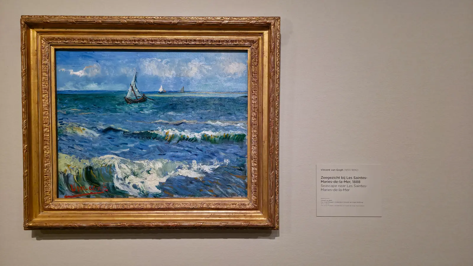 Van Gogh's Seascape near Les Saintes-Maries-de-la-Mer (1888), a sailing boat on rough green and blue palette-knife waves with a red Vincent signature lower left, Van Gogh Museum