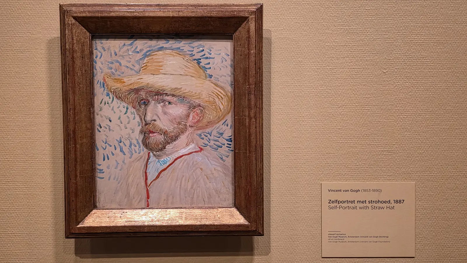 Self-Portrait with Straw Hat, 1887, oil on cardboard, blue dashes scattered on a pale ground with a red line down the smock, Van Gogh Museum