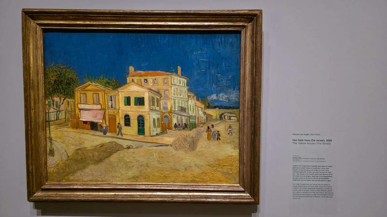 Van Gogh's The Yellow House (The Street) (1888), yellow buildings and a sandy street in Arles under a deep blue sky, at the Van Gogh Museum