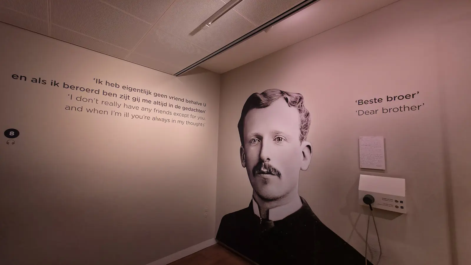 A full-height photograph of Theo van Gogh on the gallery wall beneath the words Dear brother, with a Van Gogh quote in Dutch and English, Van Gogh Museum, Amsterdam