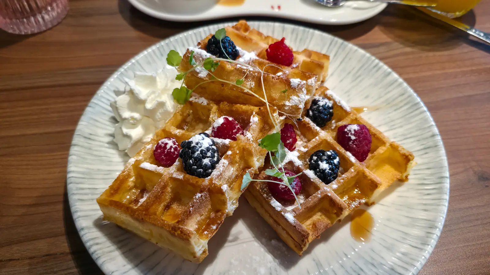 A fresh fruit waffle with raspberries, blackberries, icing sugar, whipped cream and syrup at Café Flor, Schiphol