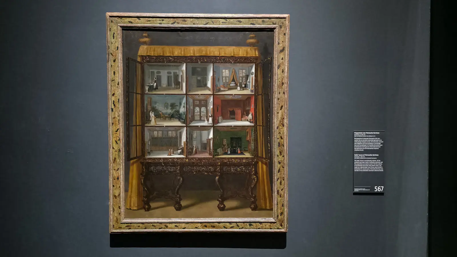 Jacob Appel's painting of Petronella Oortman's dolls' house at the Rijksmuseum, its rooms full of tiny figures