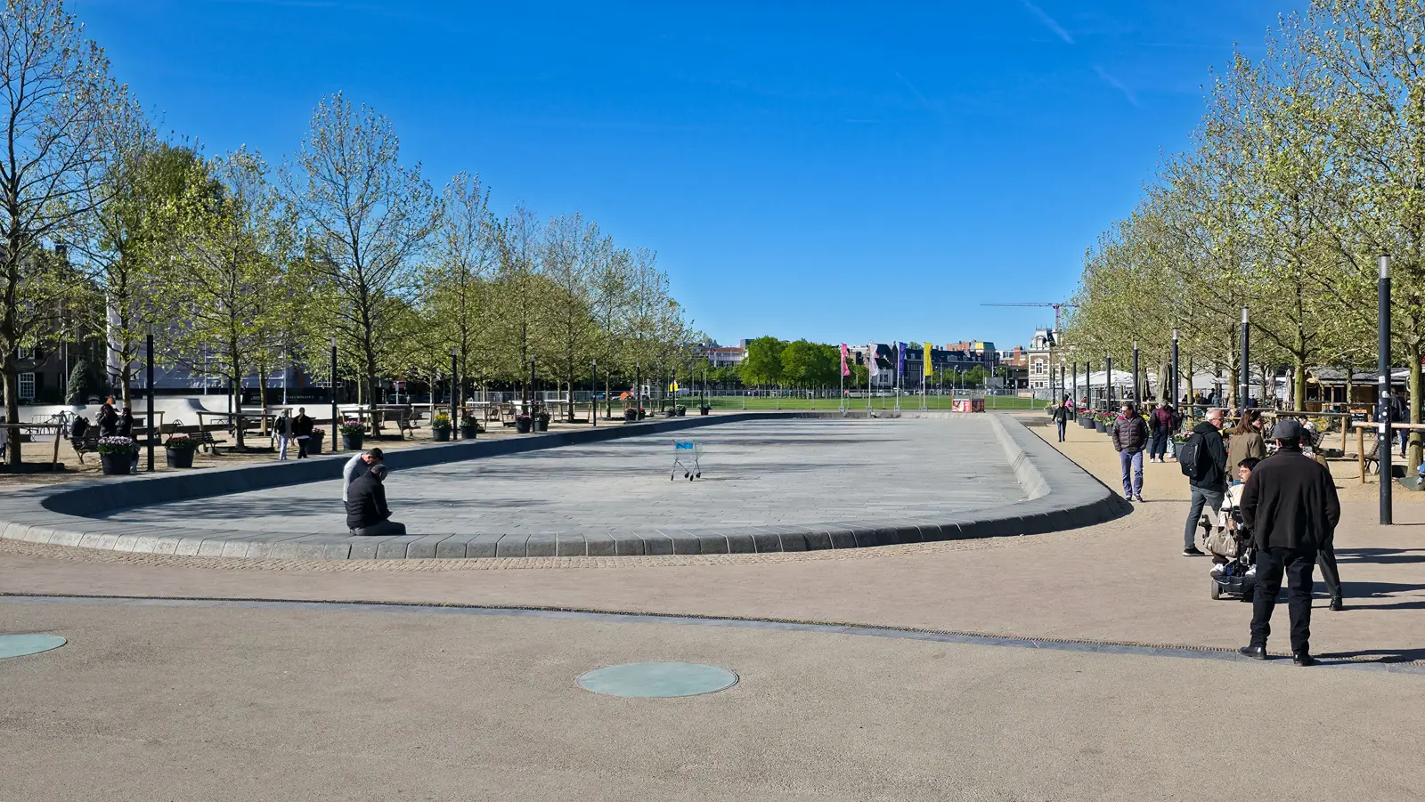 The drained pond on Museumplein, Amsterdam, with an abandoned shopping cart in the middle of the empty basin