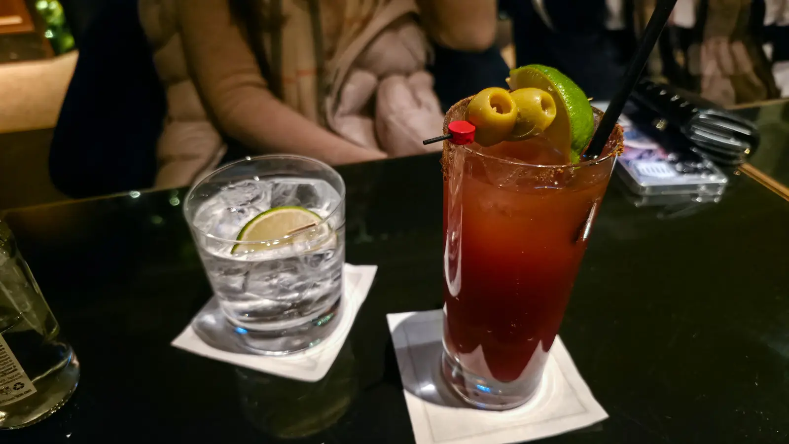 Caesar with a spiced rim, olives and lime beside a gin and tonic, Reign Bar, Fairmont Royal York, Toronto