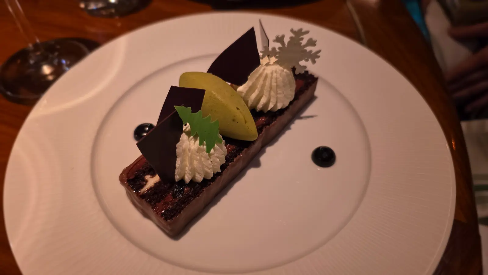 Blackforest Snow Log with chocolate shards, piped cream, pistachio gelato and a sugar snowflake, Reign, Toronto