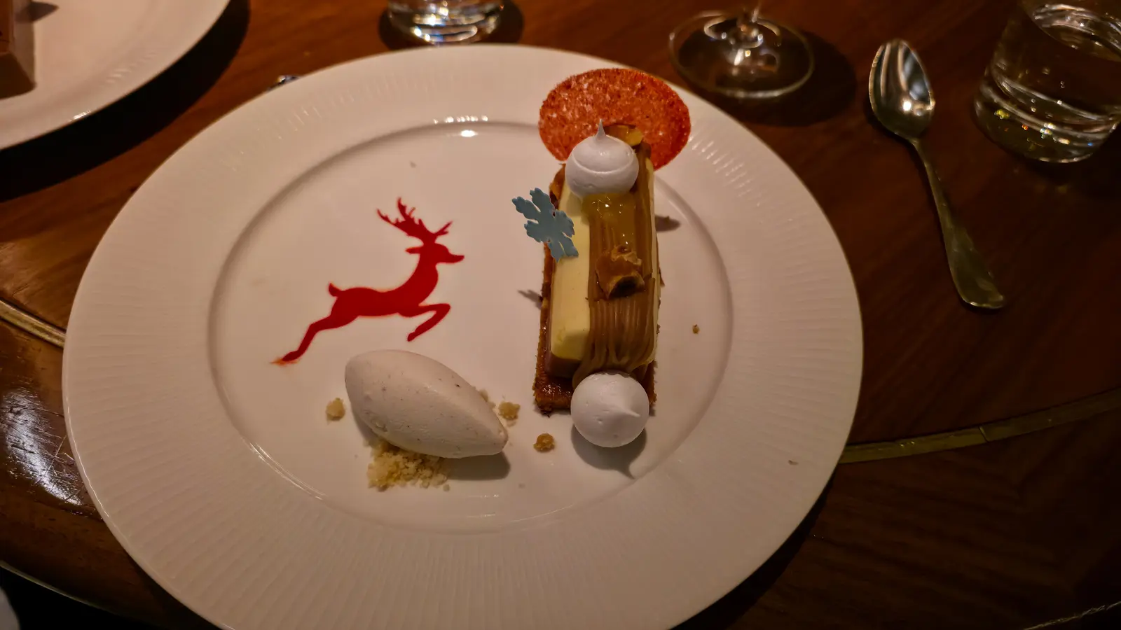 Mont Blanc with piped chestnut cream, meringues and a scoop of ice cream, beside a red reindeer on the plate, Reign, Toronto