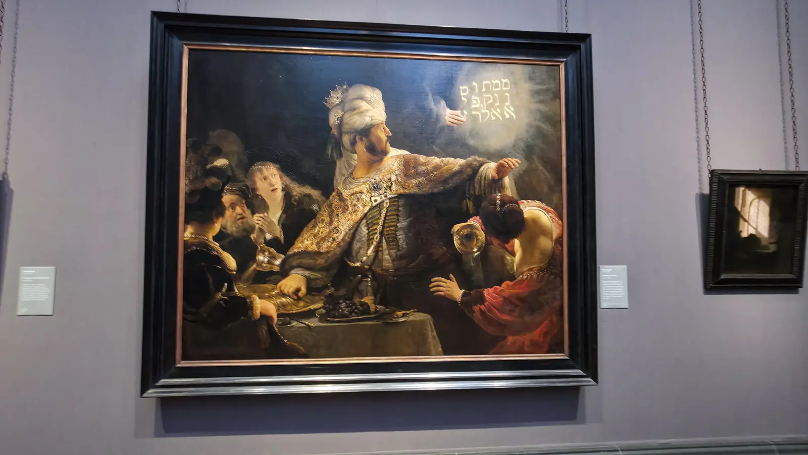 Rembrandt's Belshazzar's Feast at the National Gallery, London, the king turning from glowing Hebrew writing on the wall as a woman spills her wine