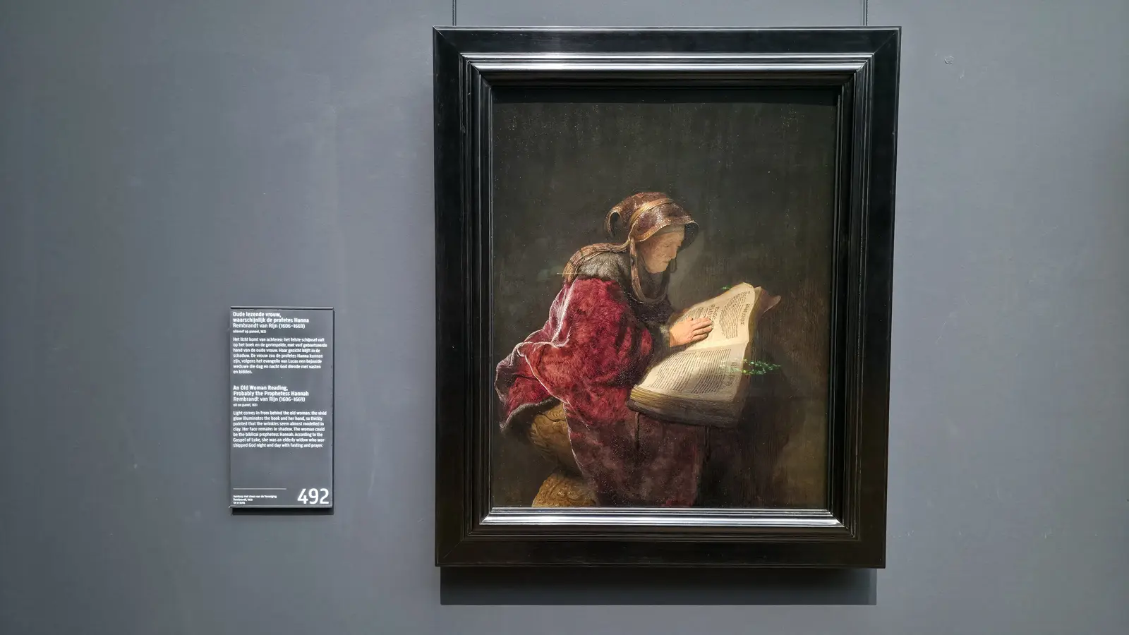 Rembrandt's An Old Woman Reading, 1631, light falling on a large book and her hand, at the Rijksmuseum