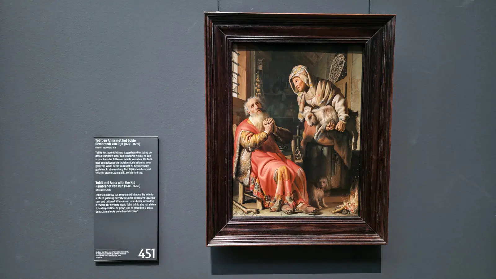 Rembrandt's Tobit and Anna with the Kid, a blind old man praying in a torn red robe as his wife holds a young goat, at the Rijksmuseum in Amsterdam