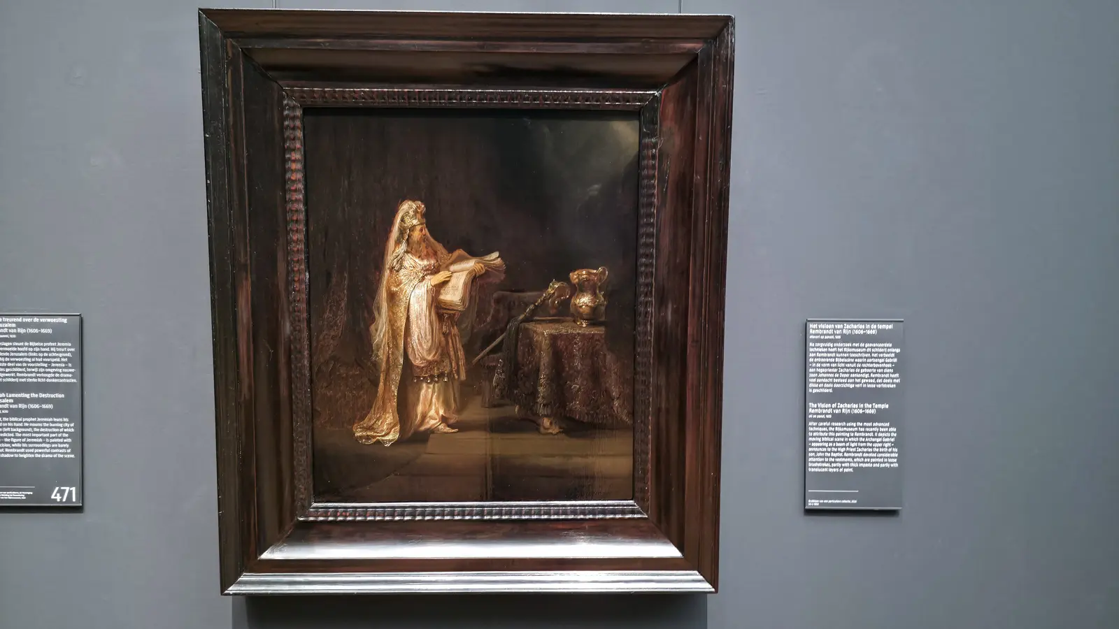 Rembrandt's Vision of Zacharias in the Temple, a high priest in gold vestments holding a book beside a table with a gold jug, at the Rijksmuseum in Amsterdam