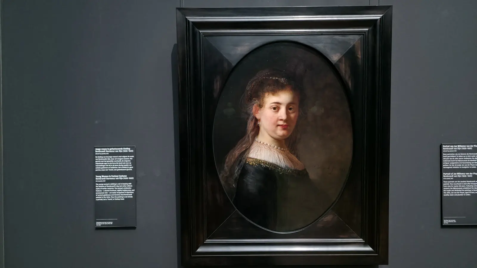 Rembrandt's Young Woman in Fantasy Costume, a young woman in a veil, pearls and gold-trimmed black dress in an oval frame, at the Rijksmuseum in Amsterdam