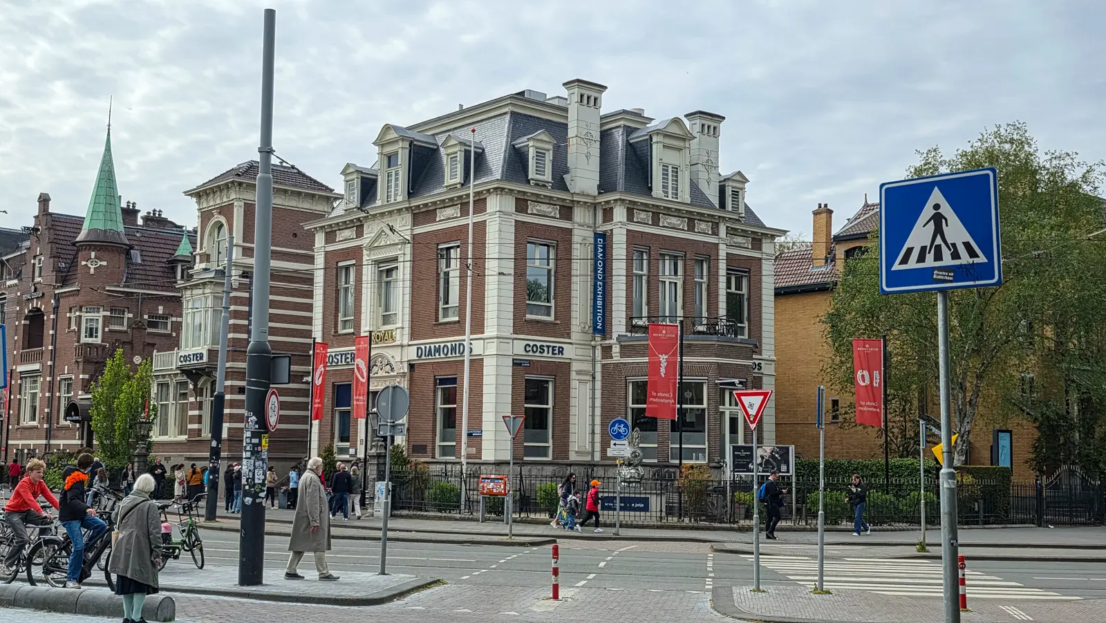 The Royal Coster Diamonds building on Paulus Potterstraat, Amsterdam, with red banners and a silver bunny by the fence