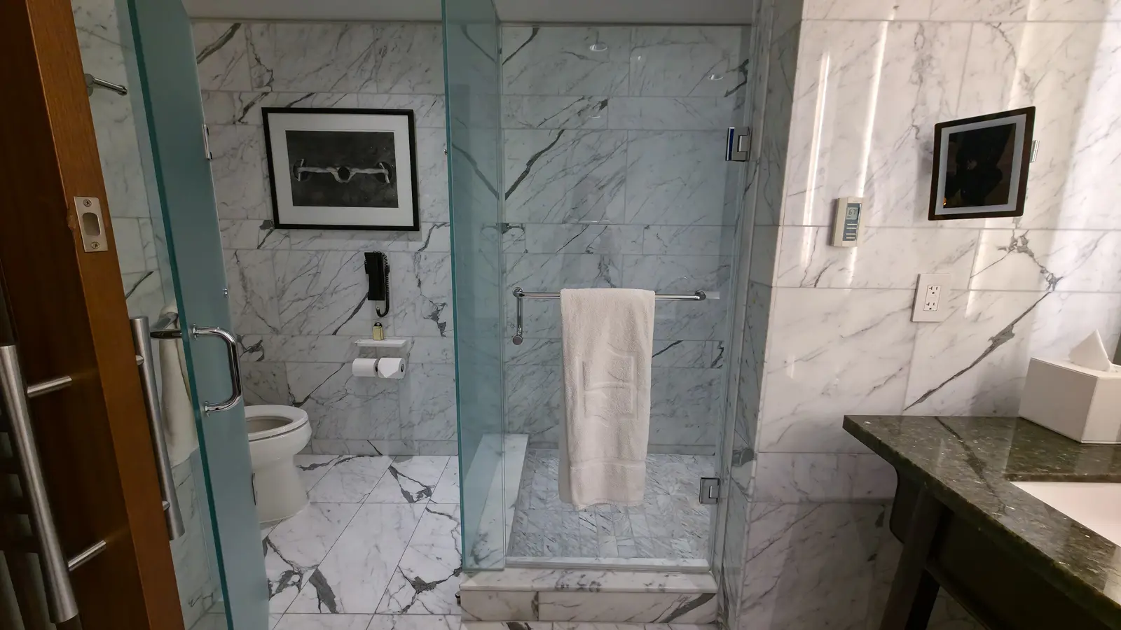 The glass walk-in shower and separate toilet area in the master bathroom of a Shangri-La Toronto suite
