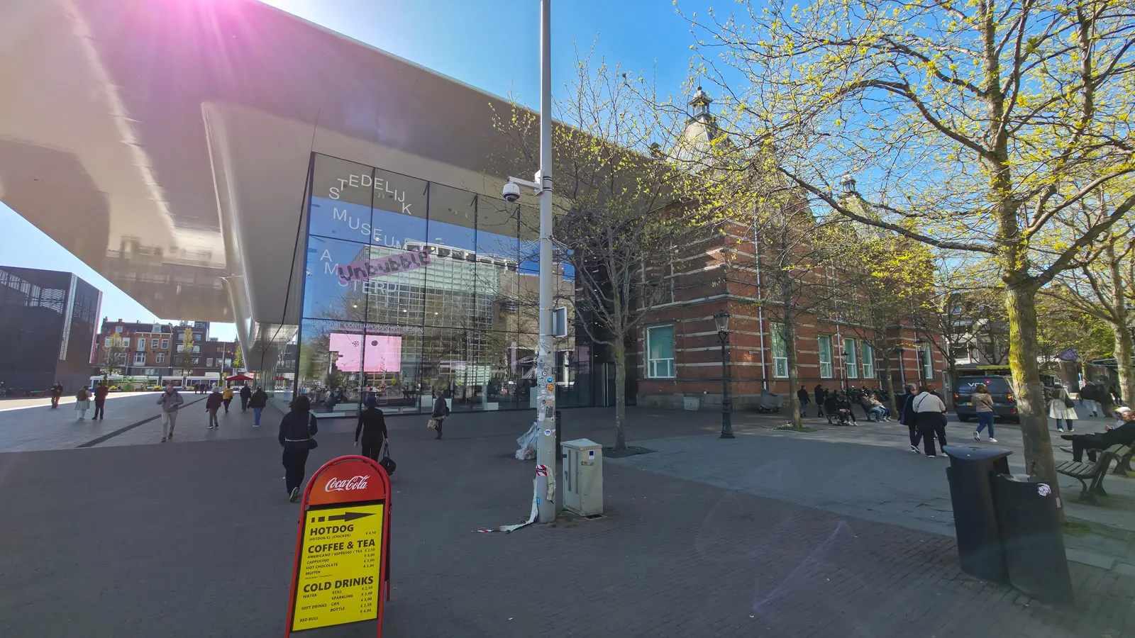 The white bathtub extension of the Stedelijk Museum beside its original red-brick building, seen from Museumplein