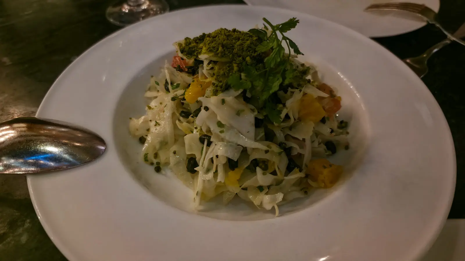 A shaved fennel salad with orange segments, ground pistachio and a sprig of chervil at The Duchess, Amsterdam