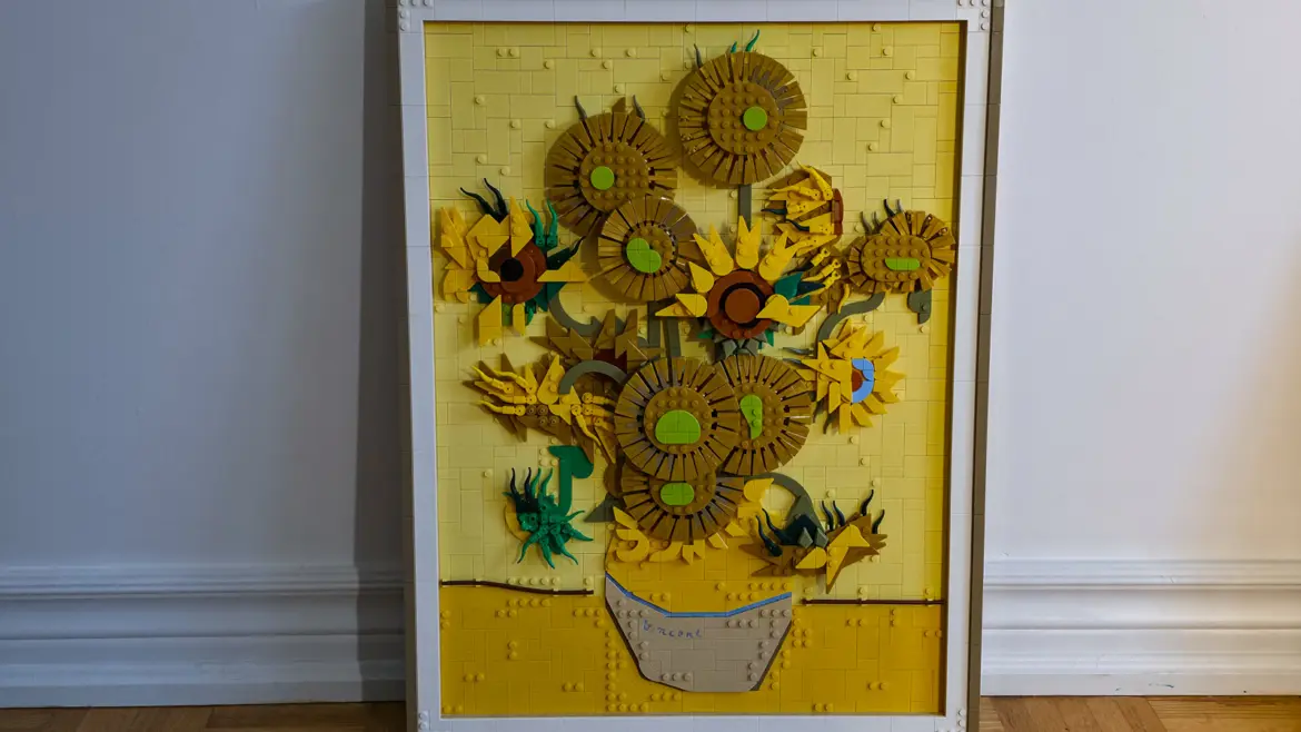 A LEGO Art Sunflowers set, a brick-built vase of sunflowers signed Vincent, propped against a white wall at home